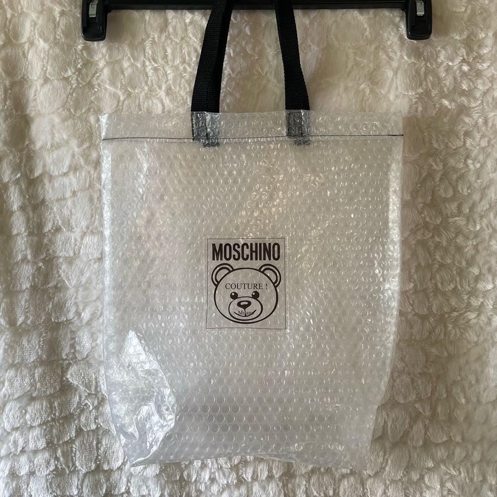 MOSCHINO Teddy couture Milano clear bubble shoe dust bag, with black handles.